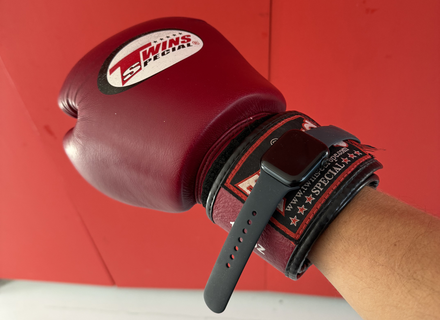 Apple Watch strapped over the cuff of a boxing glove, the wrong way to wear it