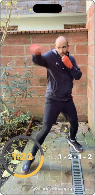 Recording from the app of a boxer shadow boxing outdoors with the round timer and the 1-2-1-2 combo shown on screen
