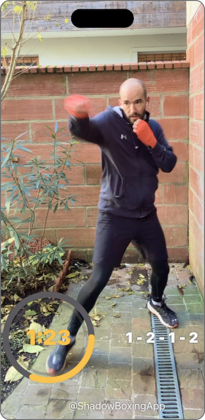 Recording from the app of a boxer shadow boxing outdoors with the round timer and the 1-2-1-2 combo shown on screen